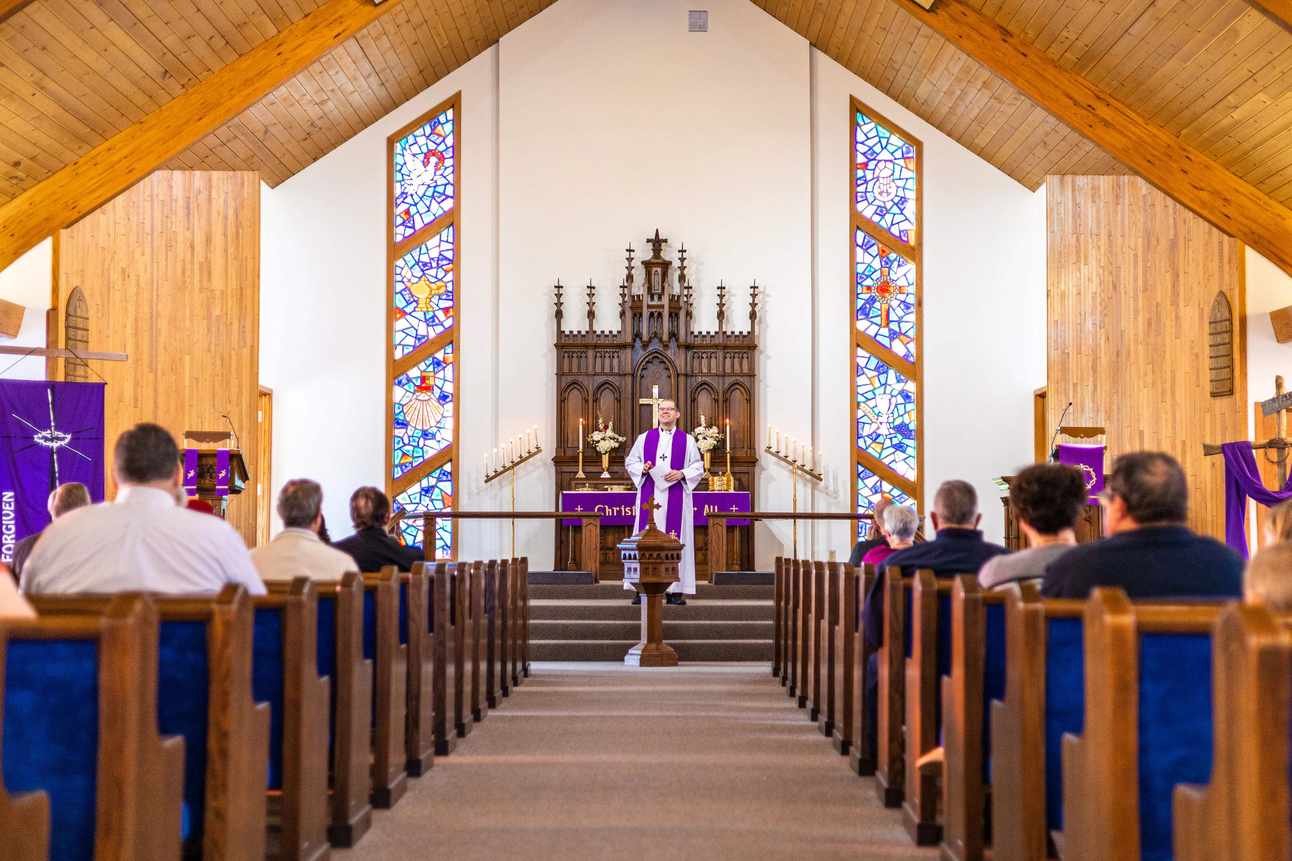 Pastor and congregation in the sanctuary during a service.
