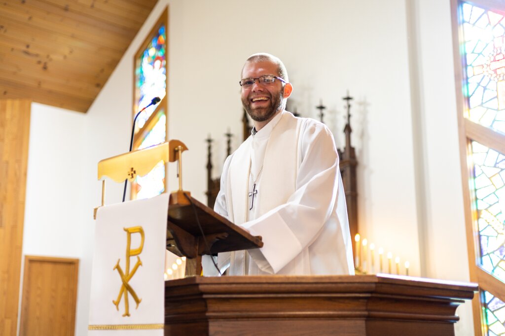 Pastor smiling in the pulpit.